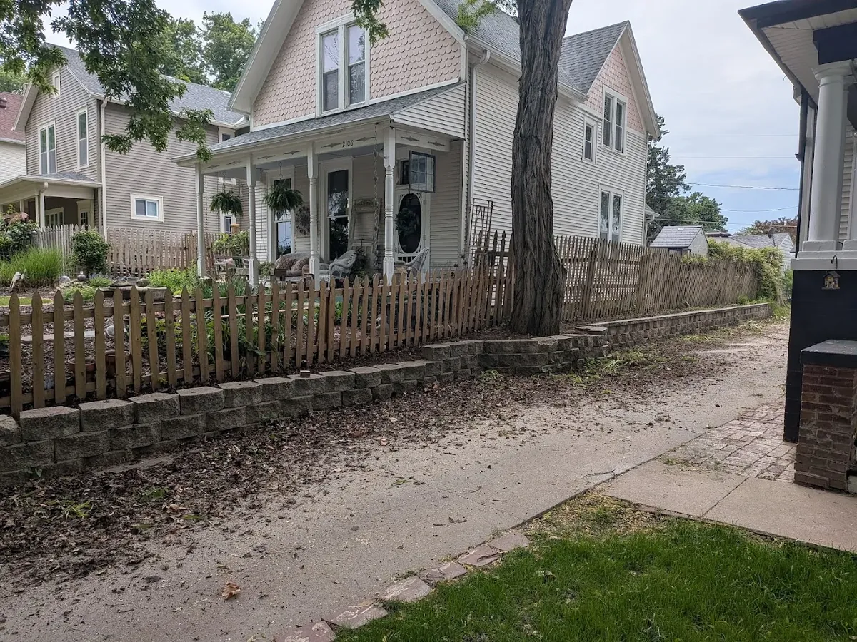 Leaves beside a residential walkway before seasonal cleanup in the Omaha area