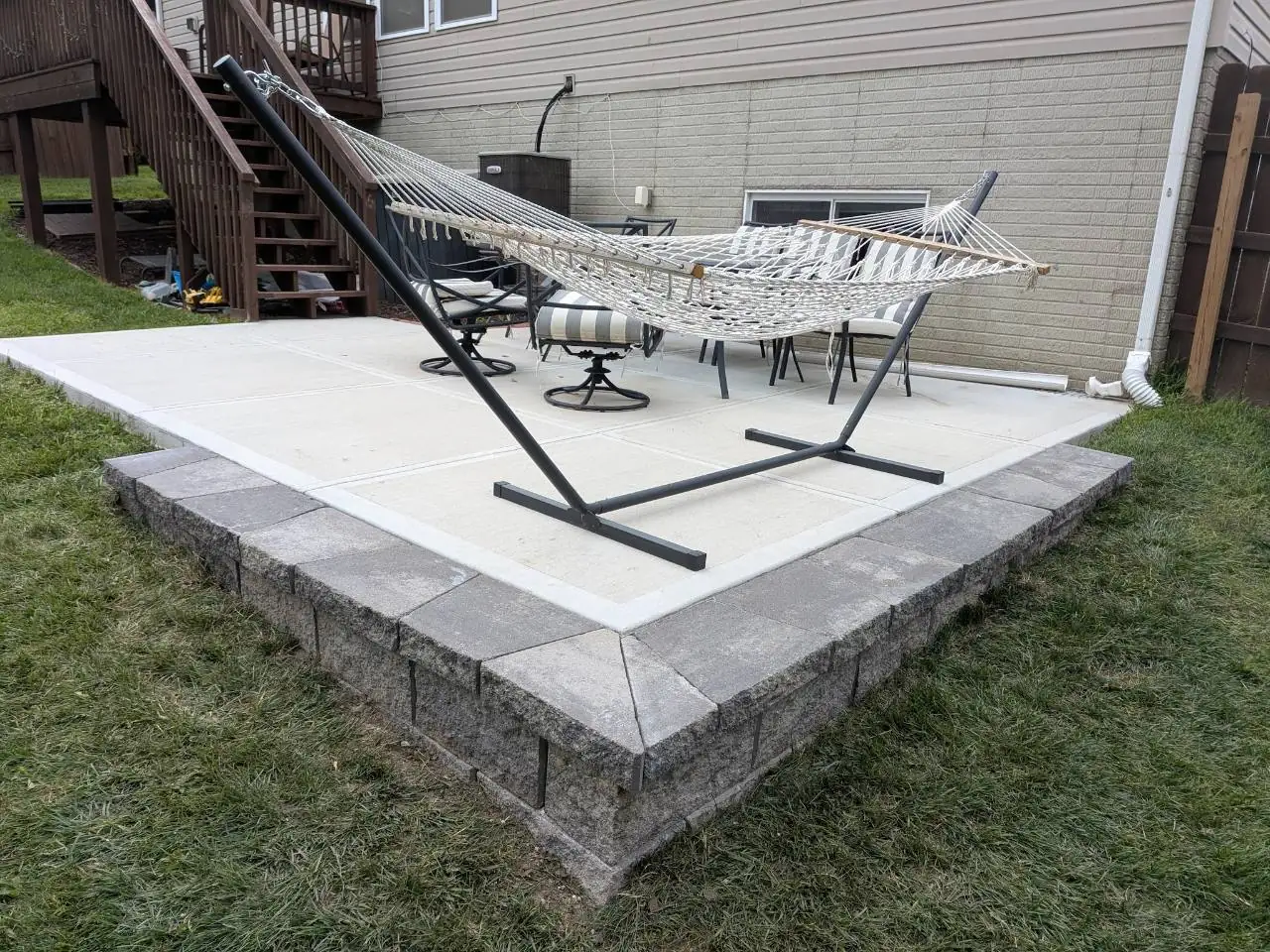 Raised patio with stone block edging at an Omaha home.
